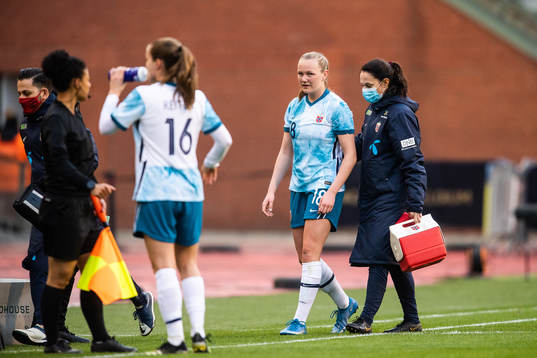 Frida Maanum of Norway leaves the pitch in pain