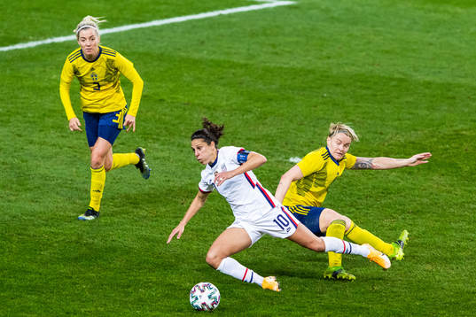 Carli Lloyd of USA and Nilla Fischer of Sweden compete for