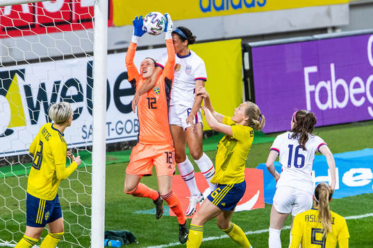 Goalkeeper Jennifer Falk of Sweden and Lynn Williams of USA