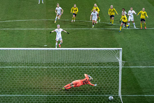 Megan Rapinoe of USA scores the 1-1 goal behind goalkeeper