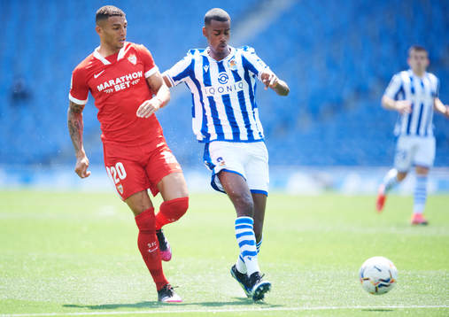 Alexander Isak of Real Sociedad duels for the ball with