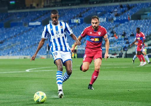 Alexander Isak of Real Sociedad duels for the ball with