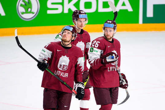 Rihards Bukarts and Uvis Balinskis of Latvia look dejected