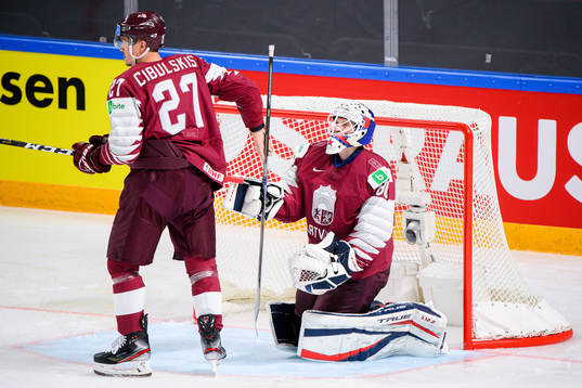 Oskars Cibulskis and Goalkeeper Matiss Kivlenieks of Latvia