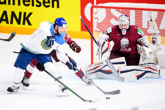 Arkady Shestakov of Kazakhstan against Goalkeeper Matiss