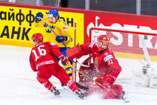 Adrian Kempe of Sweden competes for the puck with Geoff