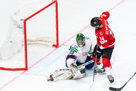 Goalkeeper Henrik Haukeland of Norway and Adam Henrique of