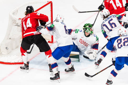 Adam Henrique of Canada acores 2-0 behind goalkeeper Henrik
