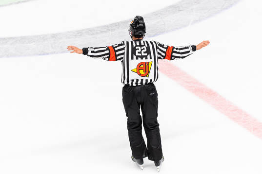 A referee calls ”No Goal”