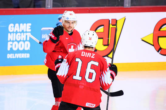 Sven Andrighetto and Raphael Diaz of Switzerland celebrate