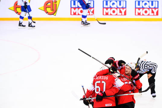 Janis Moser and Romain Loeffel of Switzerland celebrate the