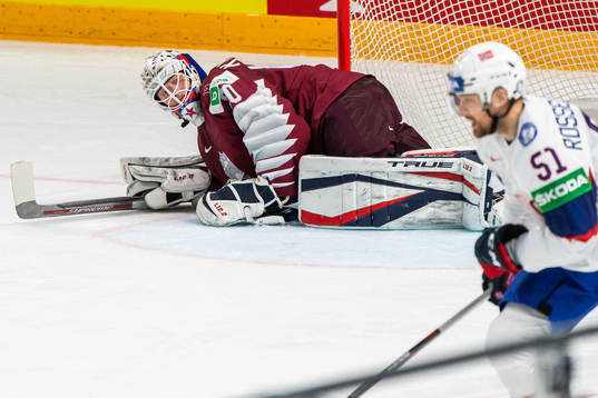 Goalkeeper Matiss Kivlenieks of Latvia and Mats Rosseli