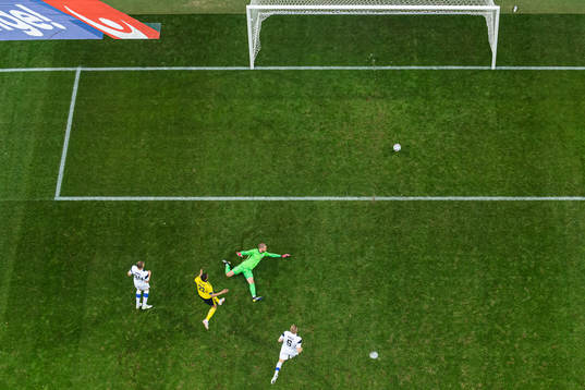 Robin Quaison of Sweden scores 1-0 behind goalkeeper Jesse