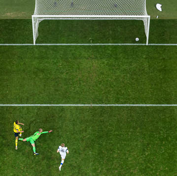 Robin Quaison of Sweden scores 1-0 behind goalkeeper Jesse