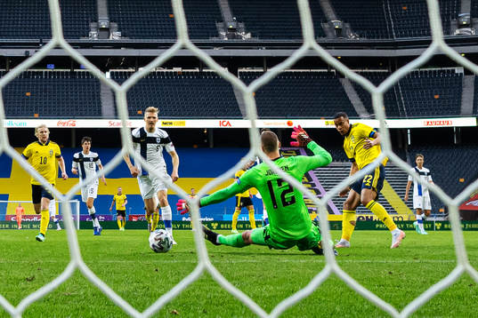 Robin Quaison of Sweden scores the 1-0 goal behind
