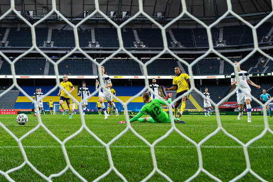 Robin Quaison of Sweden scores the 1-0 goal behind