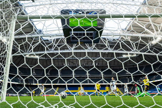 Robin Quaison of Sweden scores the 1-0 goal behind