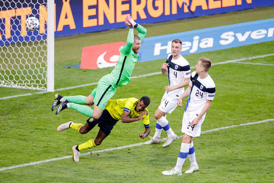Goalkeeper Jesse Joronen of Finland and Alexander Isak of
