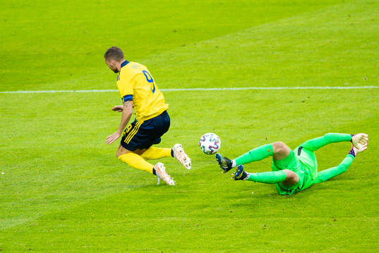 Marcus Berg of Sweden and goalkeeper Jesse Joronen of