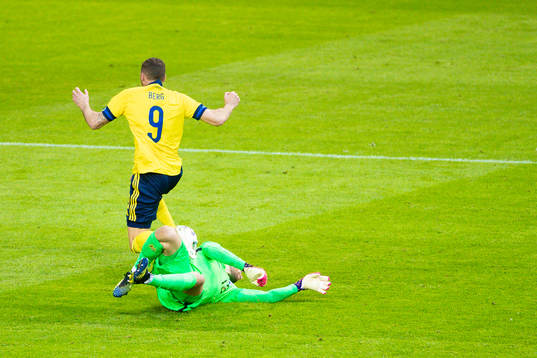 Marcus Berg of Sweden and goalkeeper Jesse Joronen of