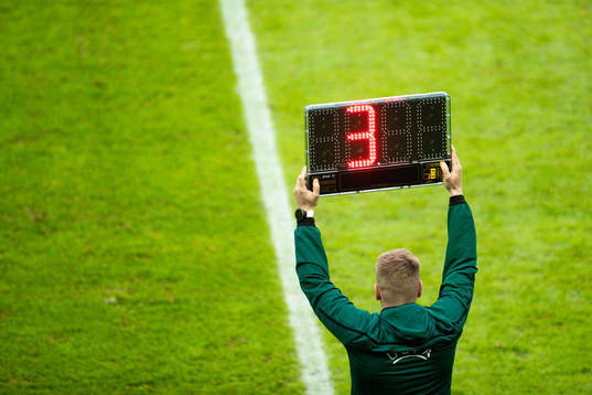A sign shows three minutes overtime