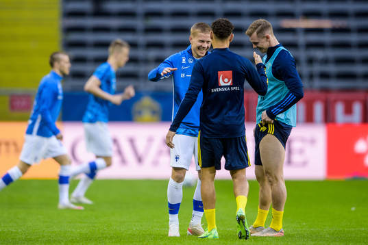 Jere Uronen of Finland with Emil Krafth and Jordan Larsson
