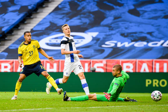 Robin Quaison of Sweden scores the 1-0 goal behind Robert