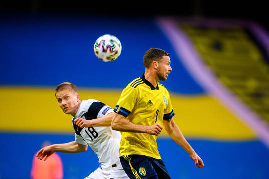 Jere Uronen of Finland and Marcus Berg of Sweden