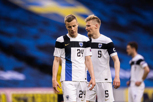 Robert Ivanov and Juhani Ojala of Finland look dejected