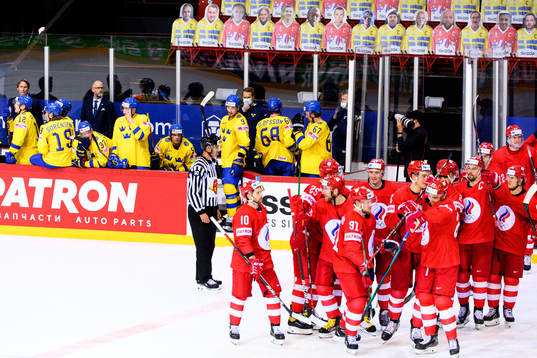 Players of Sweden look dejected as the players of Russia