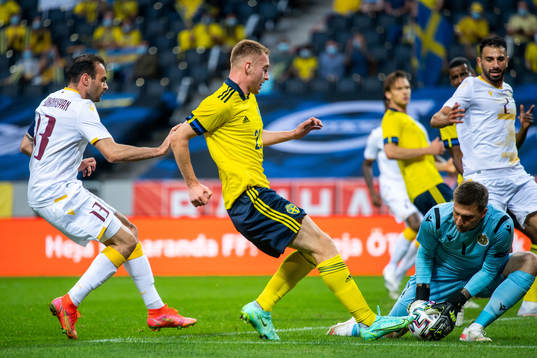 Kamo Hovhannisyan and goalkeeper Davit Yurchenko of Armenia