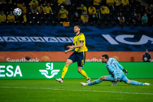 Marcus Berg of Sweden scores 3-1 behind goalkeeper Davit