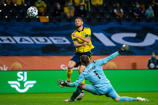 Marcus Berg of Sweden scores 3-1 behind goalkeeper Davit