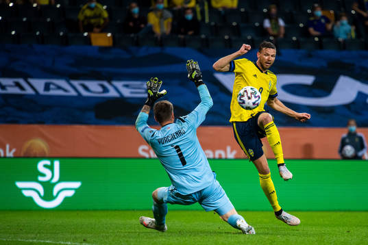 Marcus Berg of Sweden scores 3-1 behind goalkeeper Davit