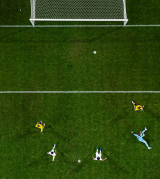 Marcus Berg of Sweden (R) scores 3-1 behind goalkeeper