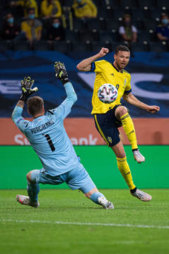 Marcus Berg of Sweden scores 3-1 behind goalkeeper Davit