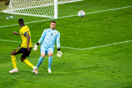 Alexander Isak of Sweden and goalkeeper Davit Yurchenko of