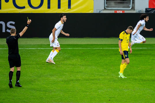 Referee Mattias Gestranius gives Viktor Claesson of Sweden