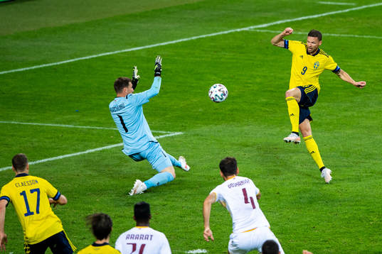 Marcus Berg of Sweden scores 3-1 behind goalkeeper Davit