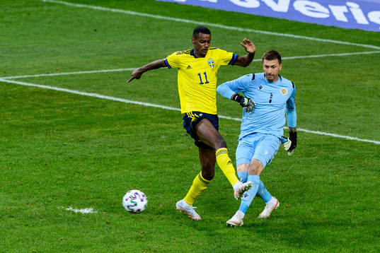 Alexander Isak of Sweden and goalkeeper Davit Yurchenko of