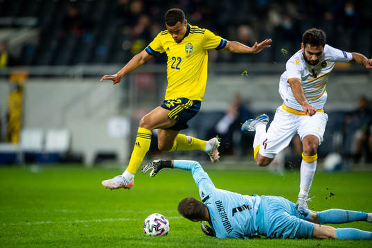 Robin Quaison of Sweden and goalkeeper Davit Yurchenko and