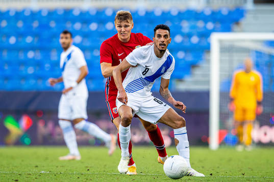 Martin Ødegaard of Norway and Carlos Zeca of Greece