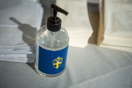 Hand disinfection against Covid-19 at a press conference