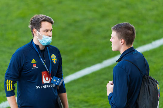 Johan Velagic, media officer, talks to Emil Holm of Sweden