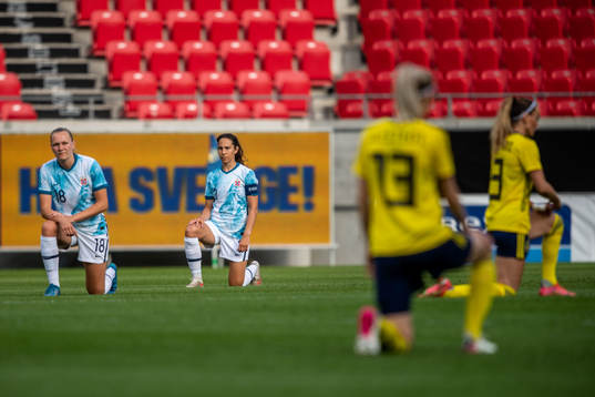 Frida Maanum and Ingrid Moe Wold of Norway takes a knee
