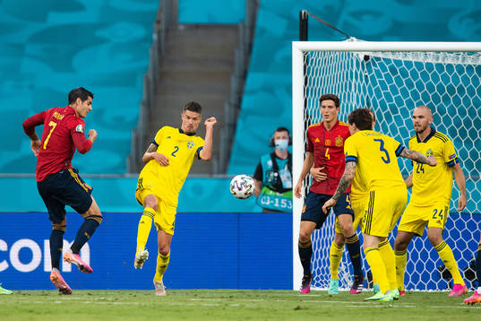 Alvaro Morata of Spain and Mikael Lustig of Sweden