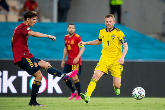 Pau Torres of Spain and Sebastian Larsson of Sweden