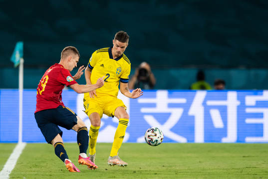 Dani Olmo of Spain and Mikael Lustig of Sweden