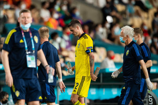 Mikael Lustig of Sweden leaves the pitch injured