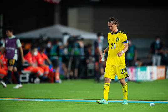 Kristoffer Olsson of Sweden leaves the pitch in pain